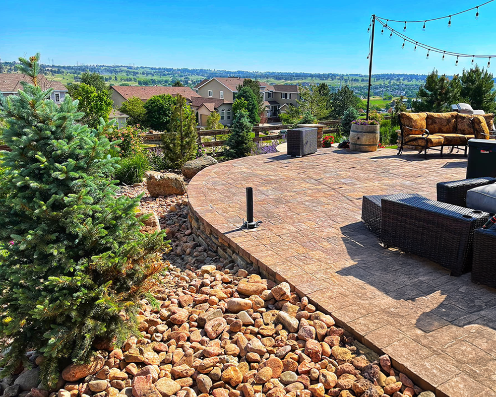 Elevated stone patio with scenic views and outdoor seating area.